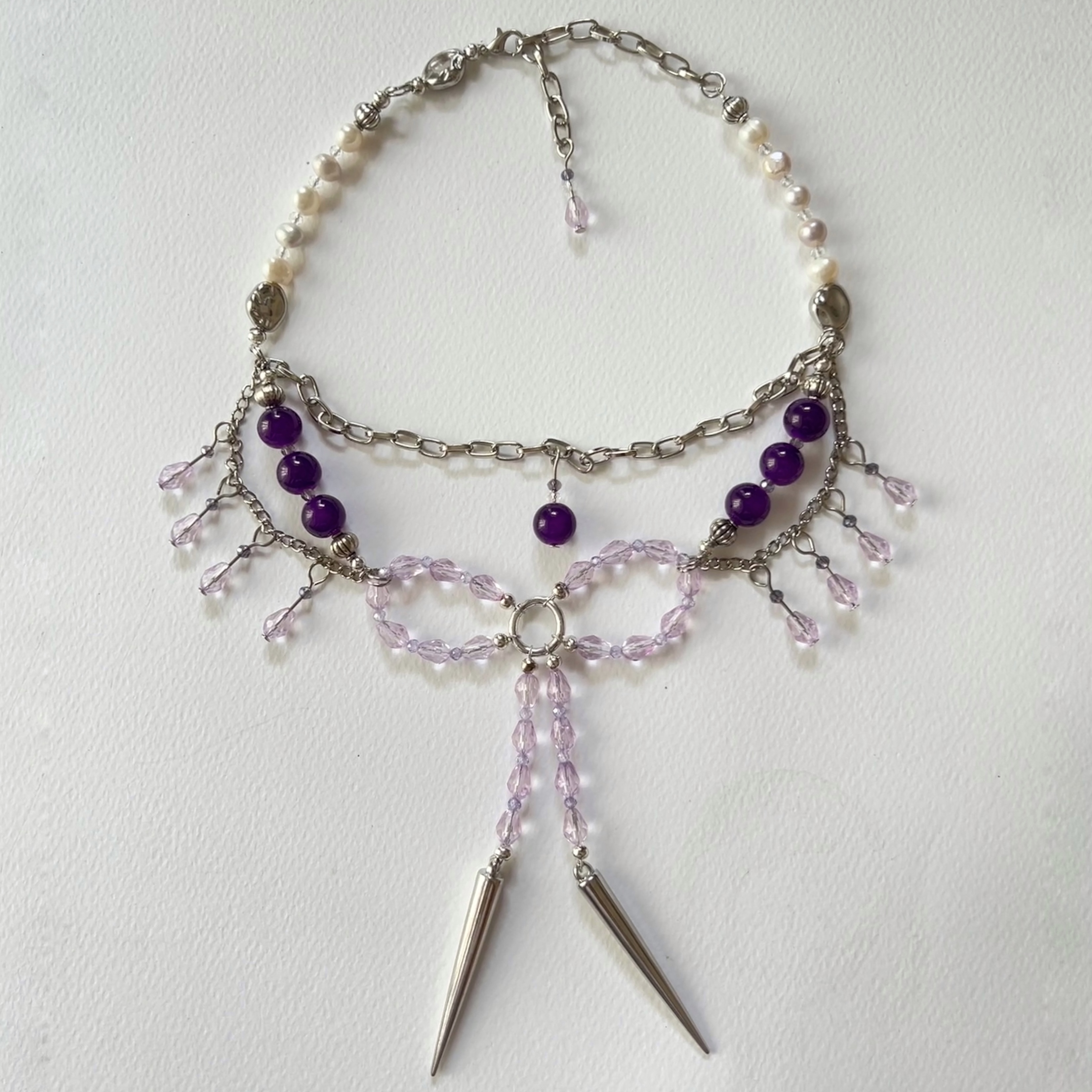 tiered necklace with purple and lavender beaded bow